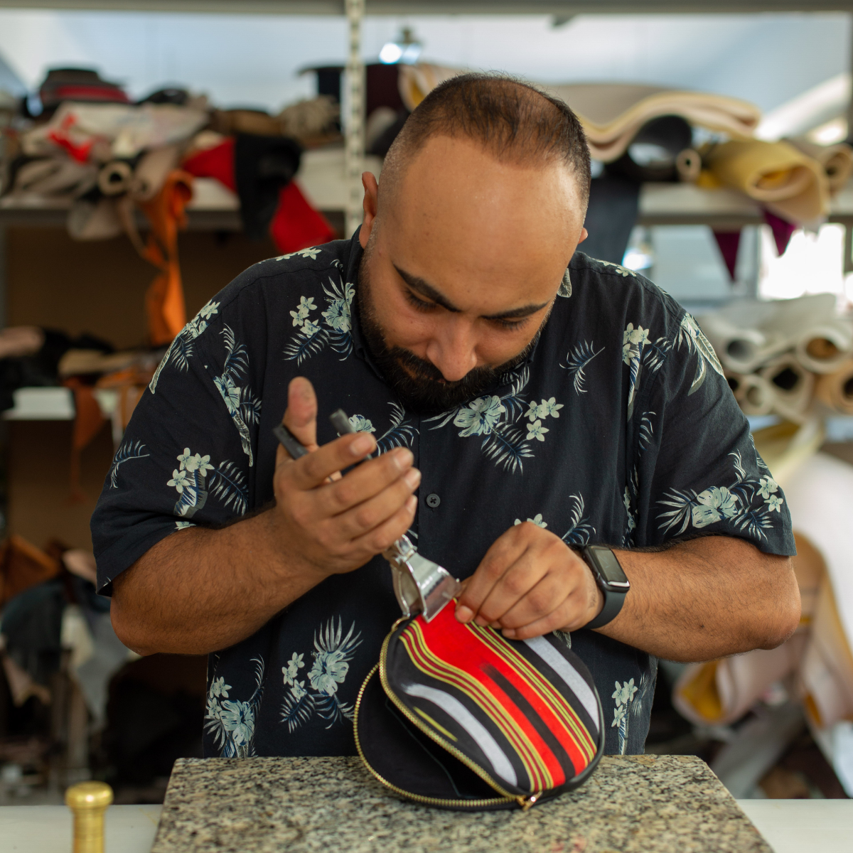 Our leather expert Samet works on Cona Maxi, making sure genuine leather and handmade fabric is attached each other